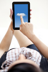 Woman with digital tablet on bed