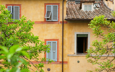 Fototapeta na wymiar Beautiful colorful walls and shutters in Siena, Italy