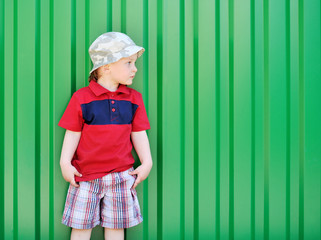 Adorable little boy looking at copyspace on green background