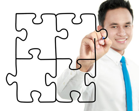 businessman drawing puzzle