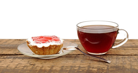 fresh cupcakes and a glass cup tea on wooden table