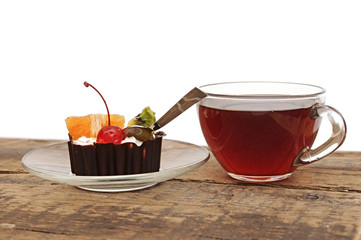 delicious cake with fruit and a cup of tea