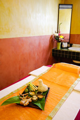 Obraz na płótnie Canvas Spa massage setting with thai herbal compress stamps in spa room