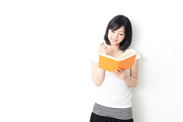 attractive asian woman reading book