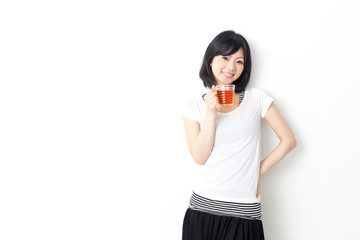 attractive asian woman drinking a cup of tea