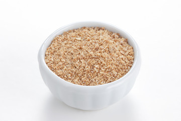 Coriander ground (Coriandrum sativum) in a white bowl on white b