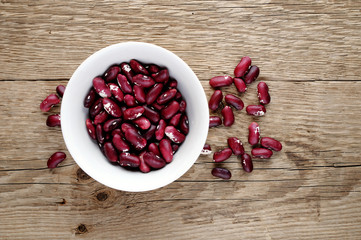 Beans in bowl on wooden background