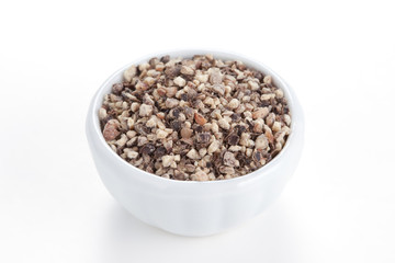 Crushed Black pepper (Piper nigrum) in a white bowl on white bac