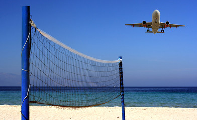 Jet flying over Volleyball net on an empty beach