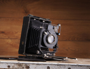 A beautiful old photo camera on a vintage background