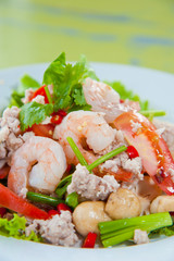 Thai dressed spicy salad with prawn, pork, green herbs and nuts