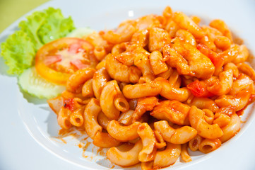 A plate of macaroni, vegetables, cheese and fresh tomatoes
