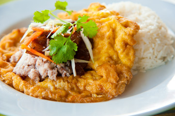 Hot rice with omelet, pork, green herbs and chili sauce