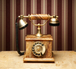 A beautiful old telephone on a vintage background