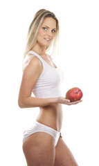 A young and sexy blond woman holding a fresh apple