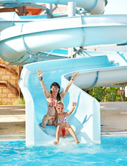 Child with mother on water slide at aquapark. - 41351455