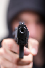 Man with gun, gangster, focus on the gun