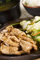 hot pan fried pork with soy sauce and vegetable.