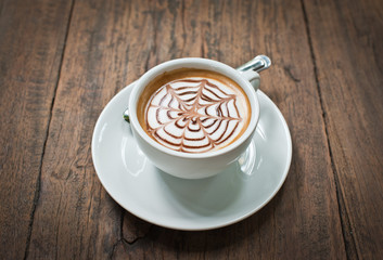 Coffee cup on wooden background