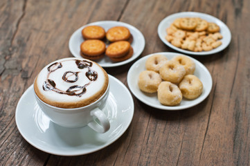 coffee cup with snack on wood table