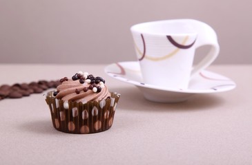 chocolate cupcake with cup of coffee