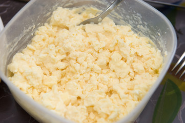 Scrambled egg in plastic bowl