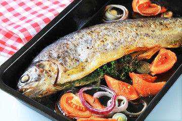 Herb-stuffed trout with tomatoes