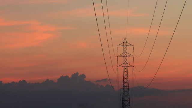electrical tower in sunset with clouds