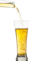 Glass of beer being poured from a bottle