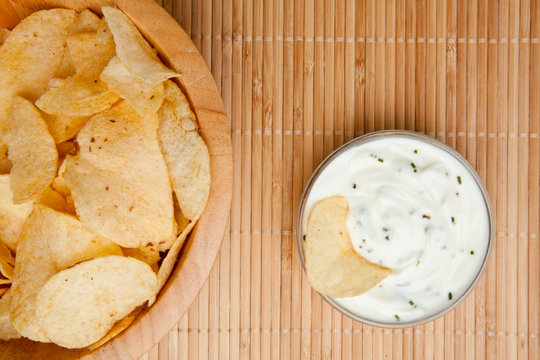 A Bowl Of Chips And A Bowl Of Dip Side By Side