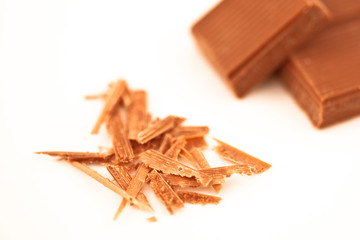 Blurred chocolate pieces and chocolate shaving