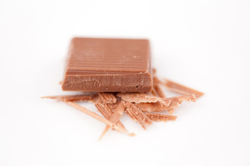 Piece of chocolate on chocolate shavings