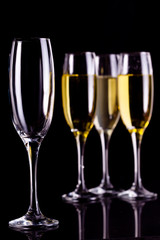 Three full glasses of champagne and one empty