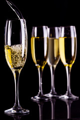 Full glasses of champagne and one being filled