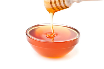 Honey trickle dropping in honey bowl