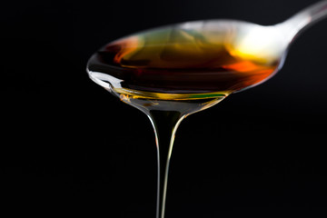 Honey trickle dropping of a full spoon