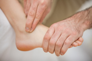 Physiotherapist massaging a barefoot