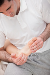 Reflexologist massaging the sole of the patient
