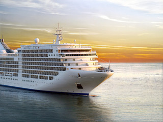 Luxury cruise ship sailing from port on sunset - obrazy, fototapety, plakaty