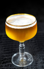 Beer into glass on a black