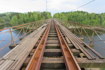 Old railway bridge over a lake. © pioregur
