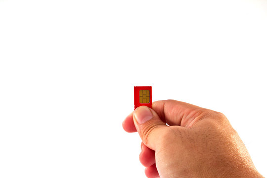 Fingers holding a mobile phone GSM SIM Card. Isolated on white b