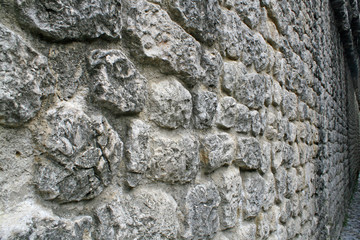 rugged ancient medieval wall made of rock and stone