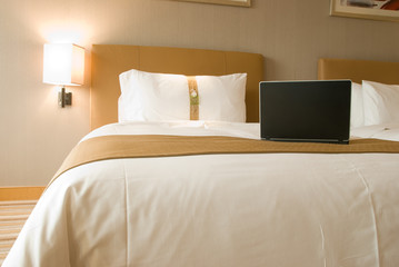 hotel bed and laptop