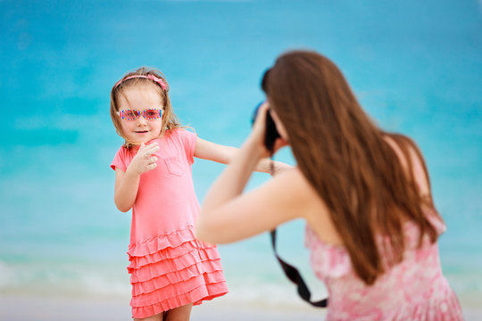 Mother photographing her daughter