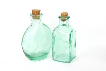 Two green glass jars with corks