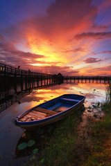 Boat and wooden bridge with a beautiful sky.