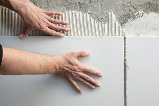 construction mason man hands on tiles work