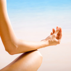 Woman doing yoga exercises or meditating