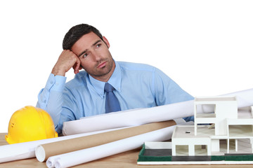 Obraz premium Bored architect sat at desk